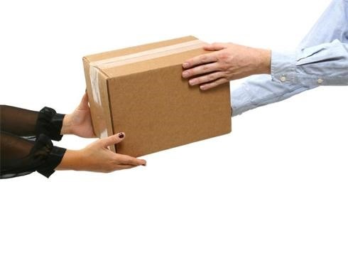 A box being handed from one person to another
